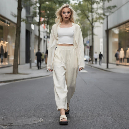 View of elegant high waisted wide leg pants in soft fabric, featuring a smooth waistband and flowing silhouette
