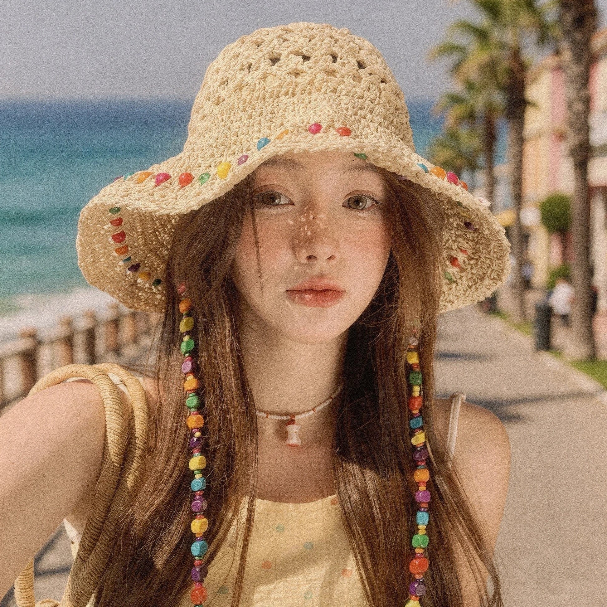 Colorful crochet summer bucket hat featuring a wide brim and intricate patterns, detailed view showcasing vibrant hues