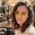 Model showcases Womens Vintage Polarized Sunglasses in a outdoor setting, paired with a breezy white blouse and high waisted denim shorts.