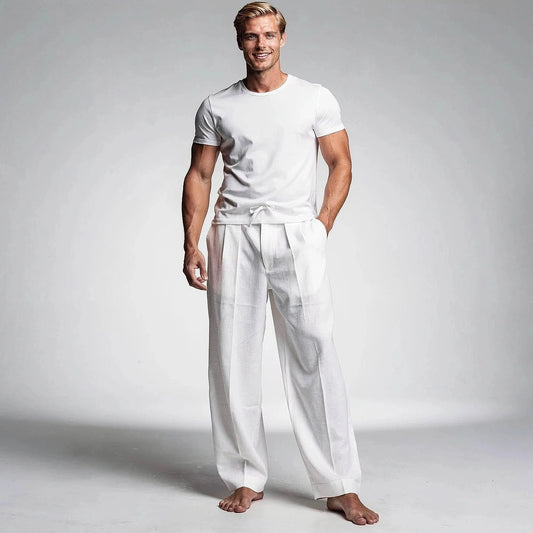 View of relaxed fit drawstring pants in light gray fabric, featuring an elastic waistband and pockets