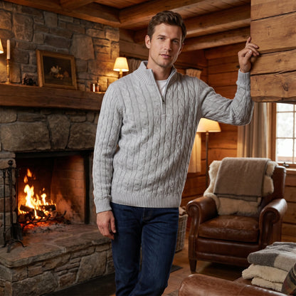 Close up view of the men's modern relaxed winter sweater showing intricate cable knit texture and detailed stitching in a rich, deep color against a neutral background.