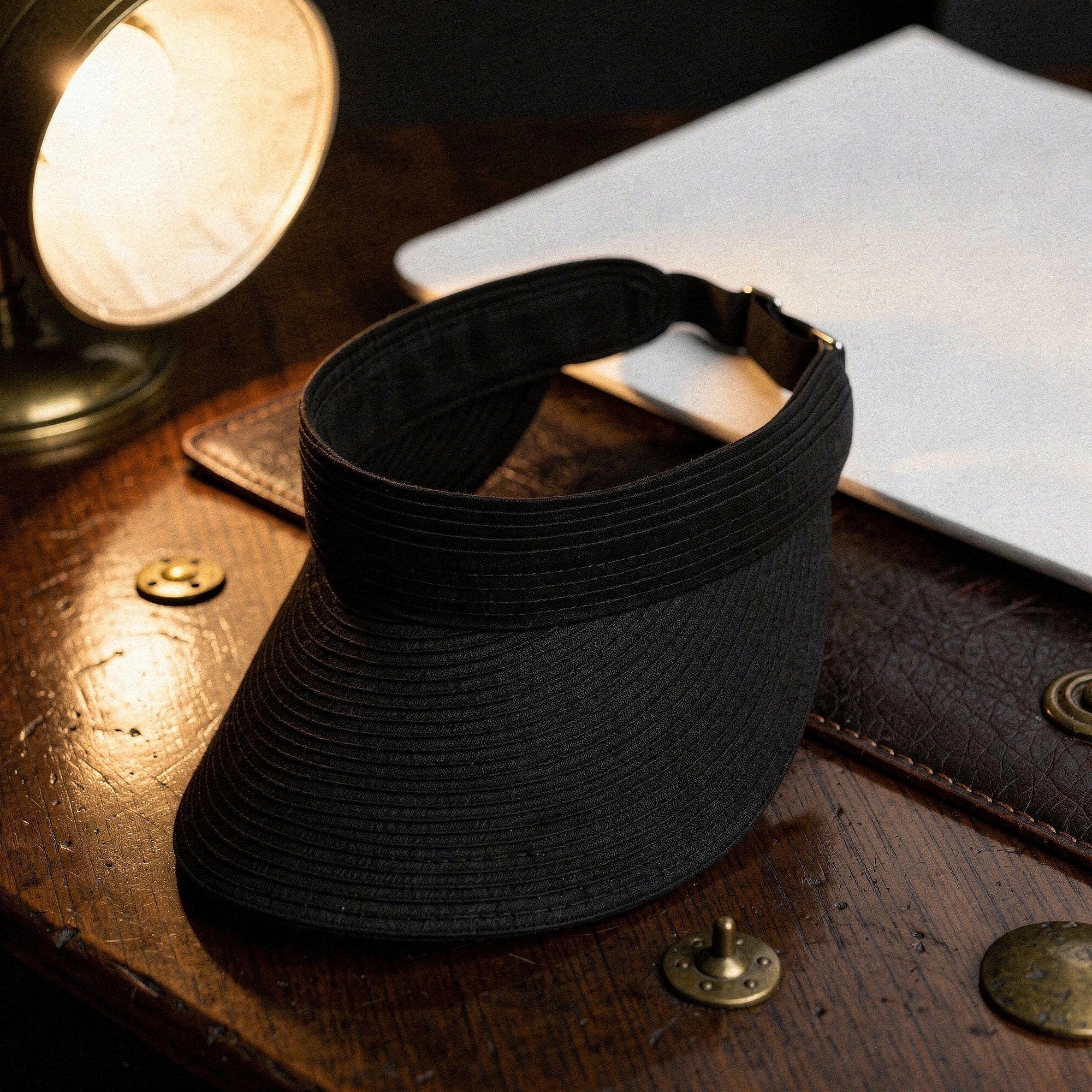 Light beige summer visor hat with a wide brim and decorative stitching, detailed view showcasing the texture and shape