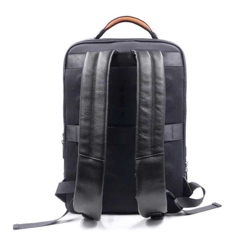 View of a sleek genuine leather backpack in dark brown, featuring a fingerprint lock and minimalist design elements