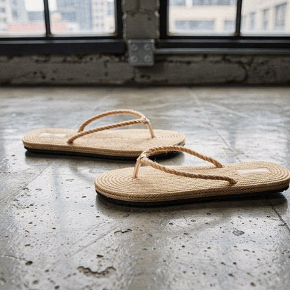 View of chic casual straw flip flop sandals in beige, featuring a textured footbed and soft straps for comfort