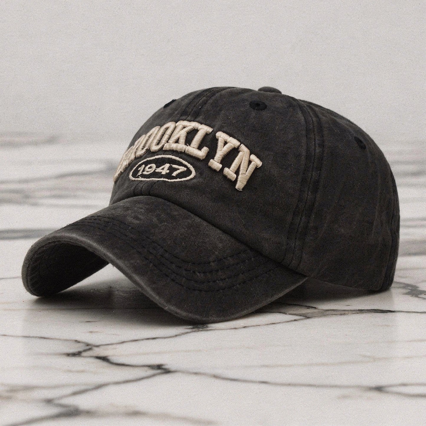 View of a navy blue embroidered cap featuring a casual chic design, made
