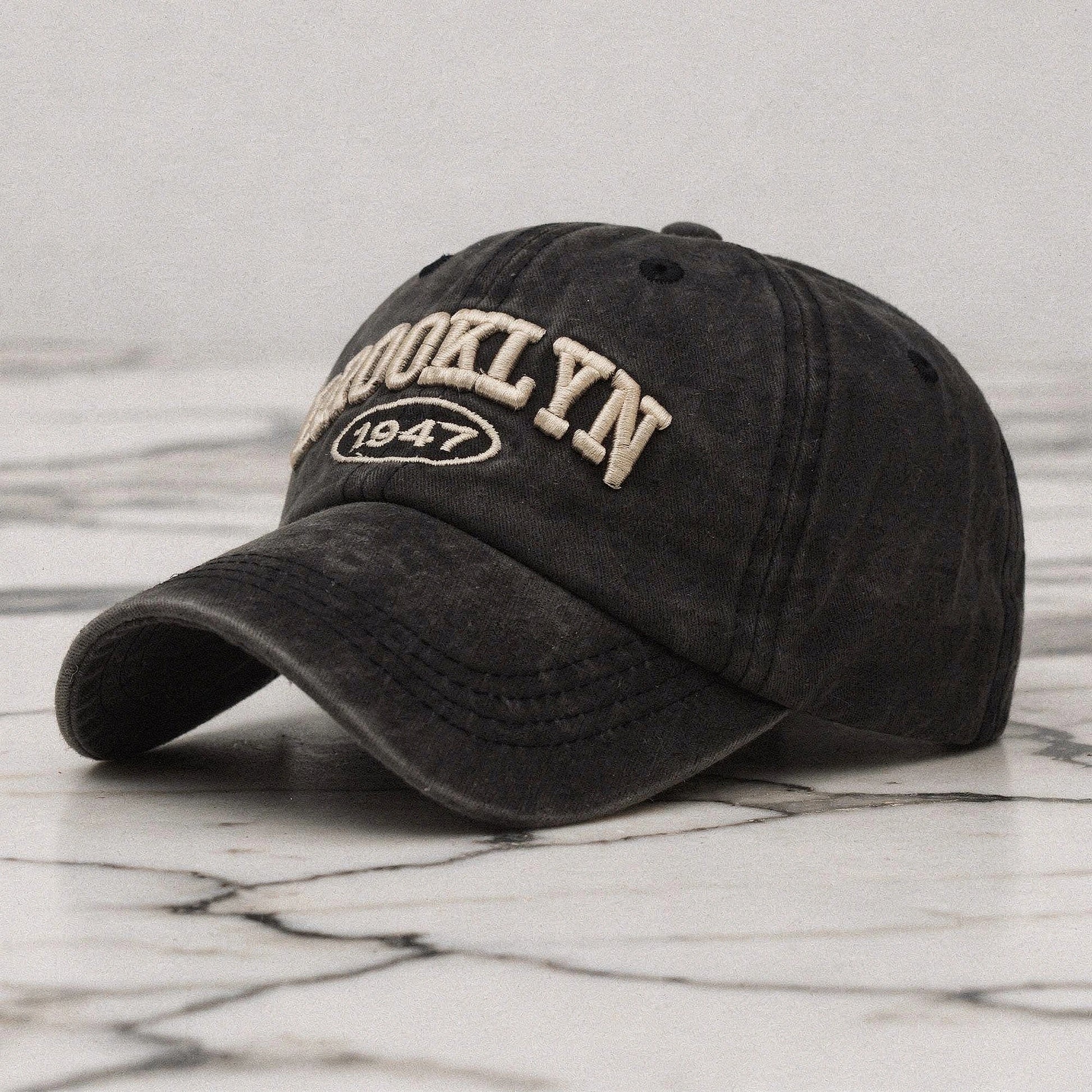 View of a navy blue embroidered cap featuring a casual chic design, made