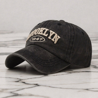 View of a navy blue embroidered cap featuring a casual chic design, made
