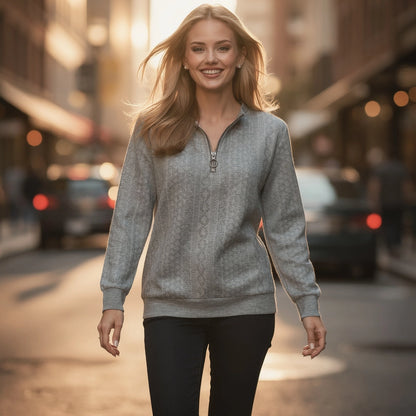 View of a soft, lightweight half zip top in elegant cream, featuring a high collar and subtle stitching details