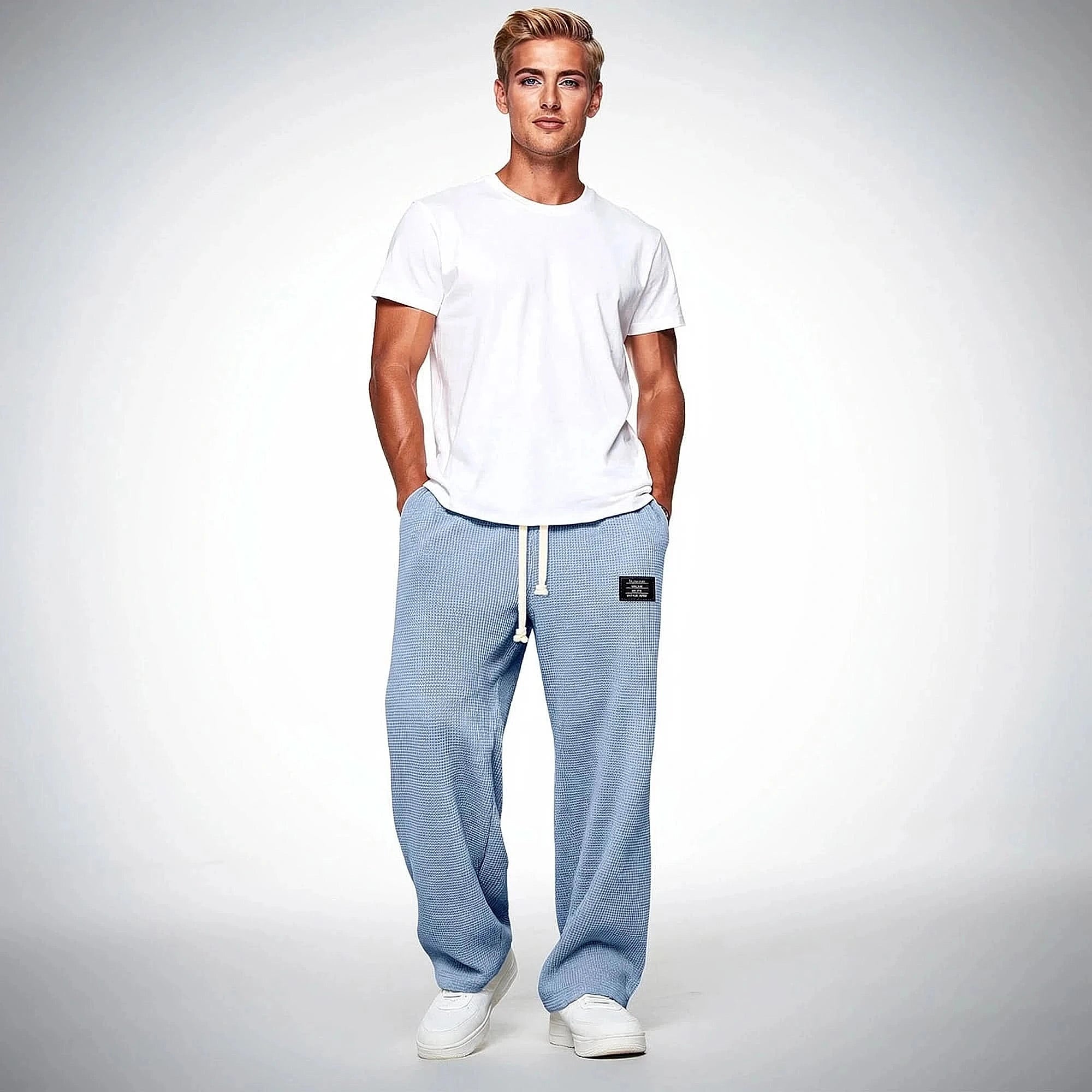 View of comfortable relaxed fit pants in soft cotton fabric, featuring a neutral beige color and an elastic waistband