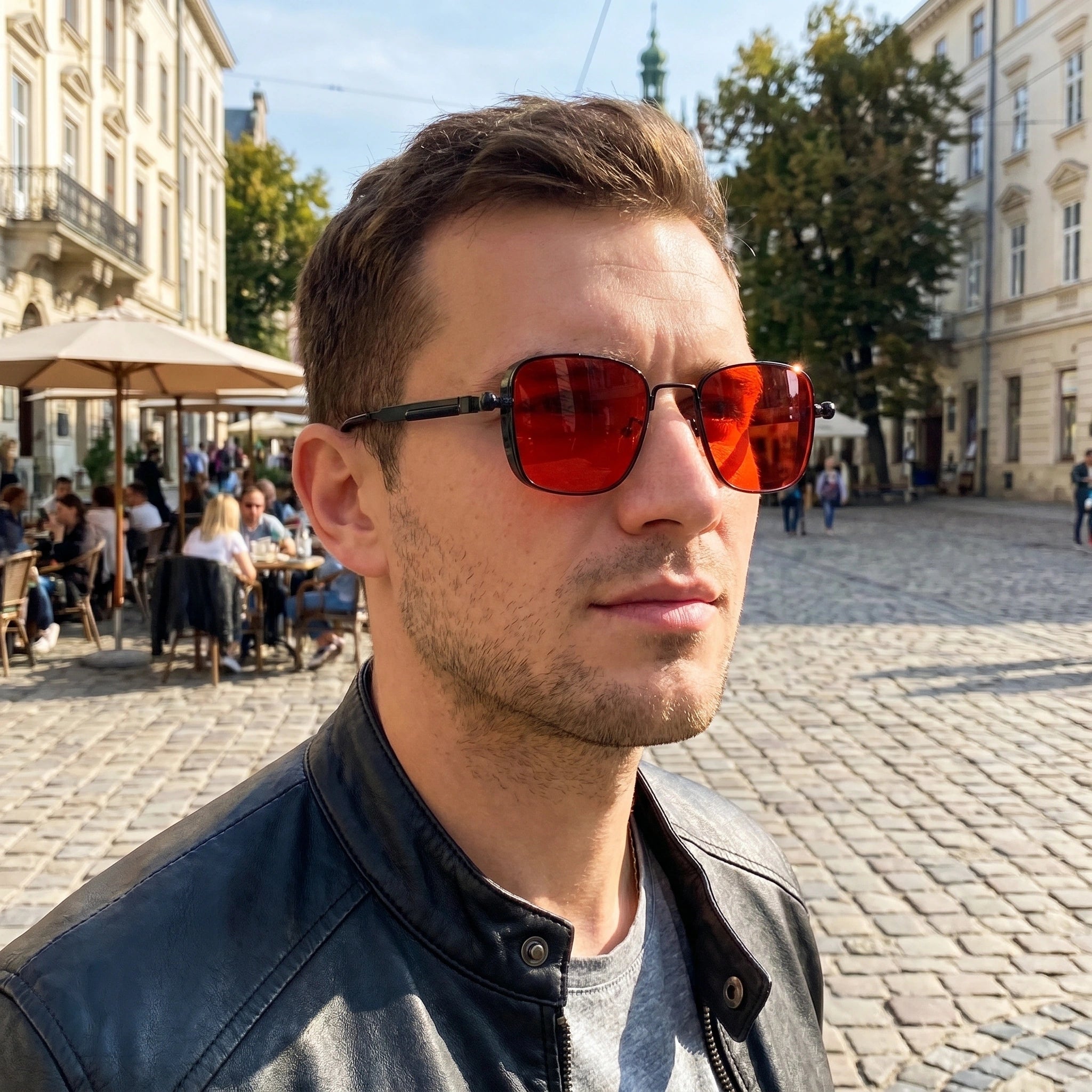 Close up of men's sleek summer sunglasses showing the polished frame, refined lenses, and intricate design elements against a soft neutral background.