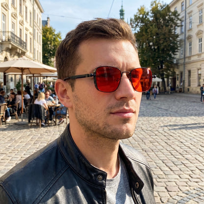 Close up of men's sleek summer sunglasses showing the polished frame, refined lenses, and intricate design elements against a soft neutral background.
