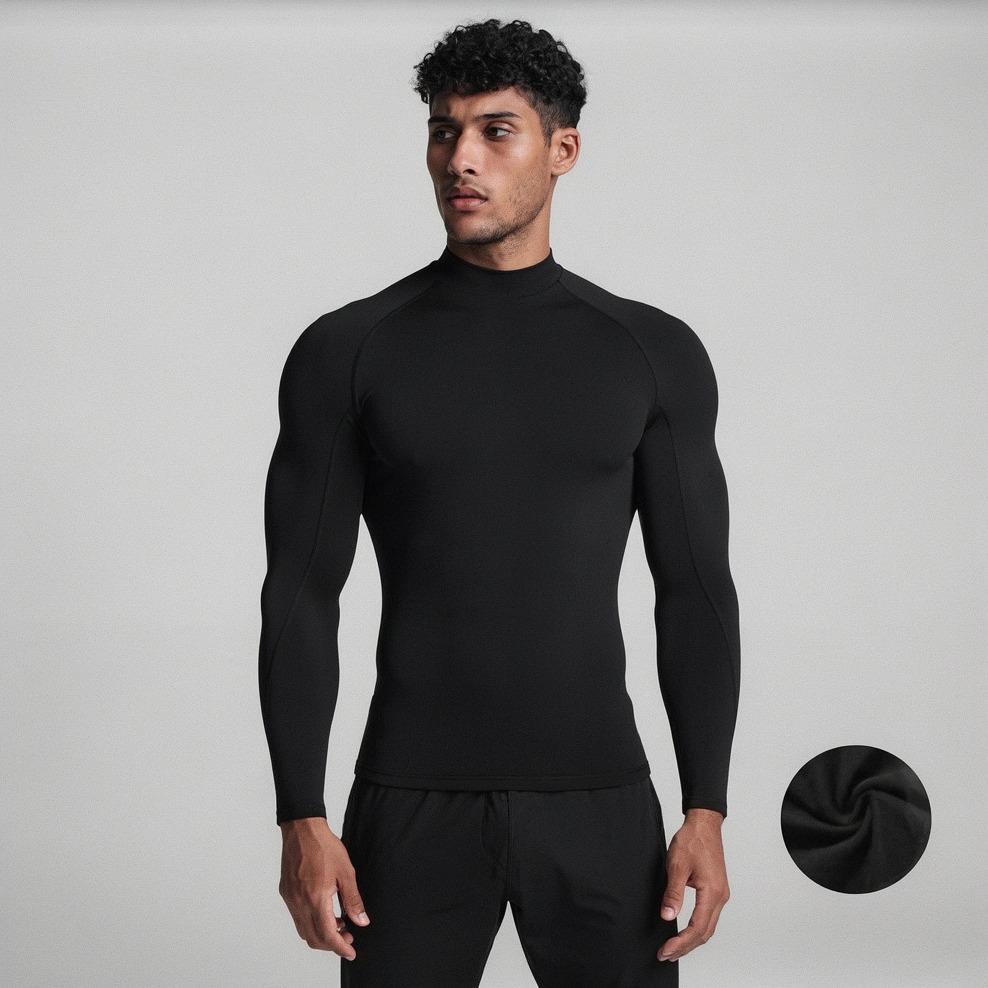 View of a black fleece backed compression winter tee with long sleeves and a fitted design