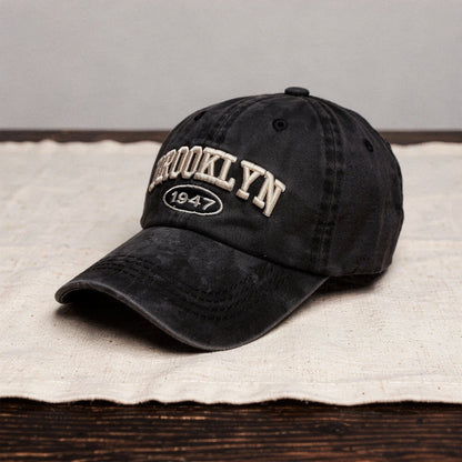 View of a men's casual cap featuring intricate embroidery, in a soft fabric, with a relaxed fit and adjustable strap