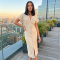 A model showcases the Womens Slim Midi Dress in a soft pastel color, styled with minimal accessories against a neutral backdrop.