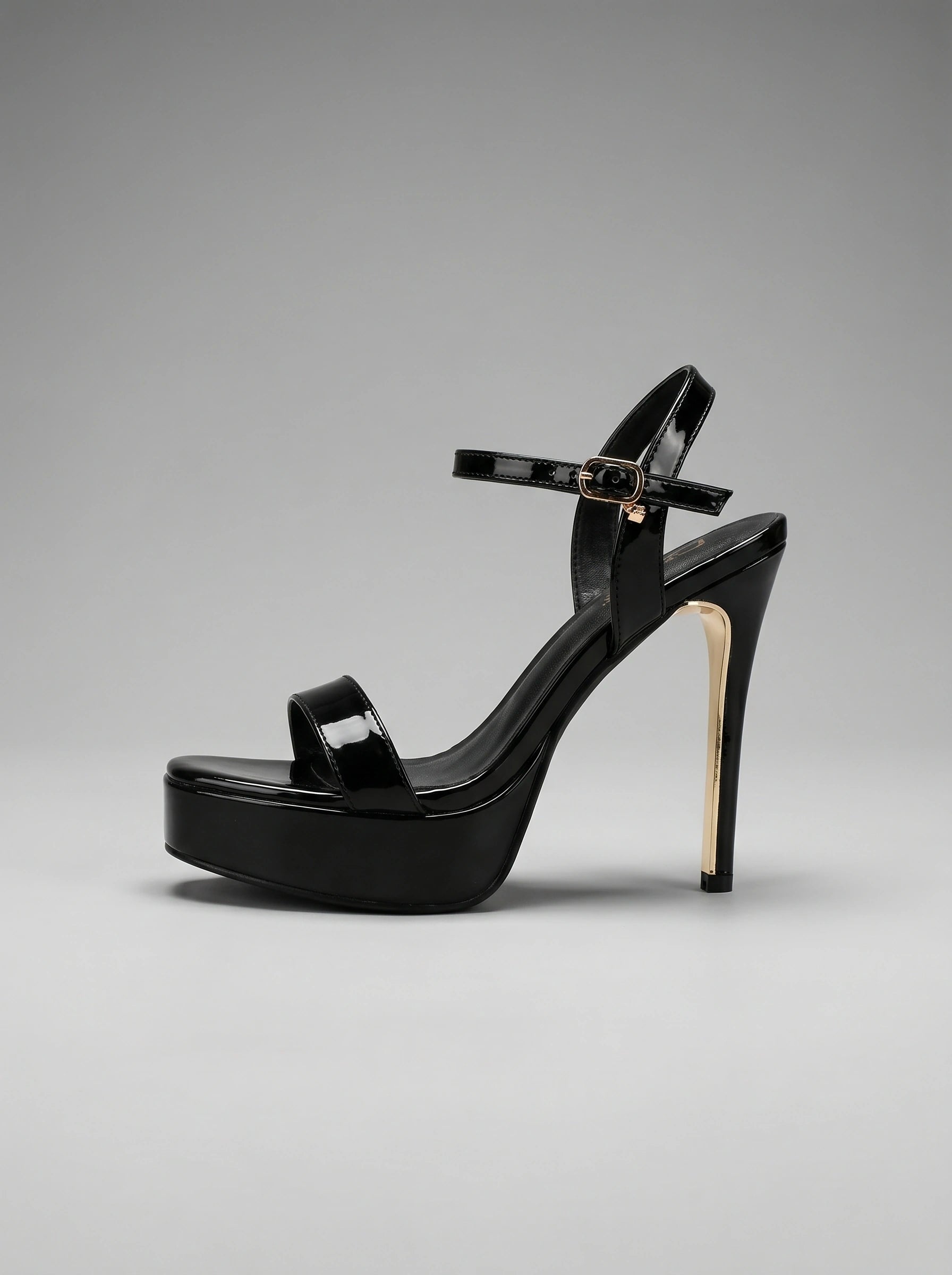 Back view of a model wearing strappy high heeled sandals, showing the intricate construction and design against a soft, neutral background.