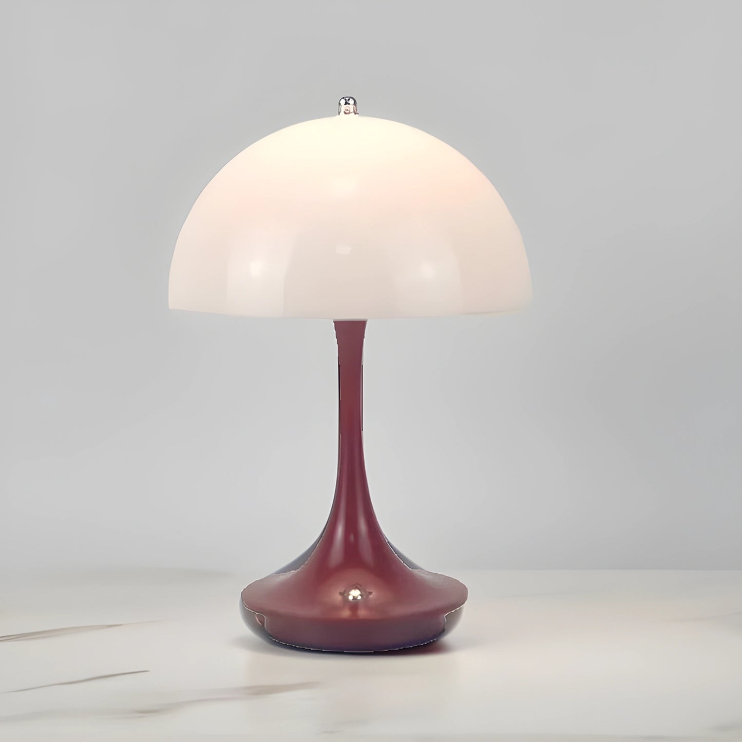 View of a sleek contemporary rechargeable table lamp in a warm metallic finish, showcasing its elegant design and modern features