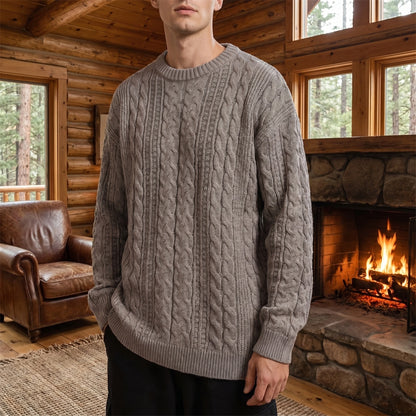 A model showcases the Mens Classic Cable Knit Quarter Zip Sweater in a rich navy color, styled with tailored trousers against a neutral backdrop.