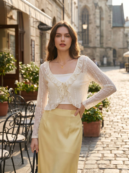 Close up view of the Womens Delicate Ruffled Summer Blouse showing the soft fabric, intricate stitching, and playful ruffled details in a light pastel color.