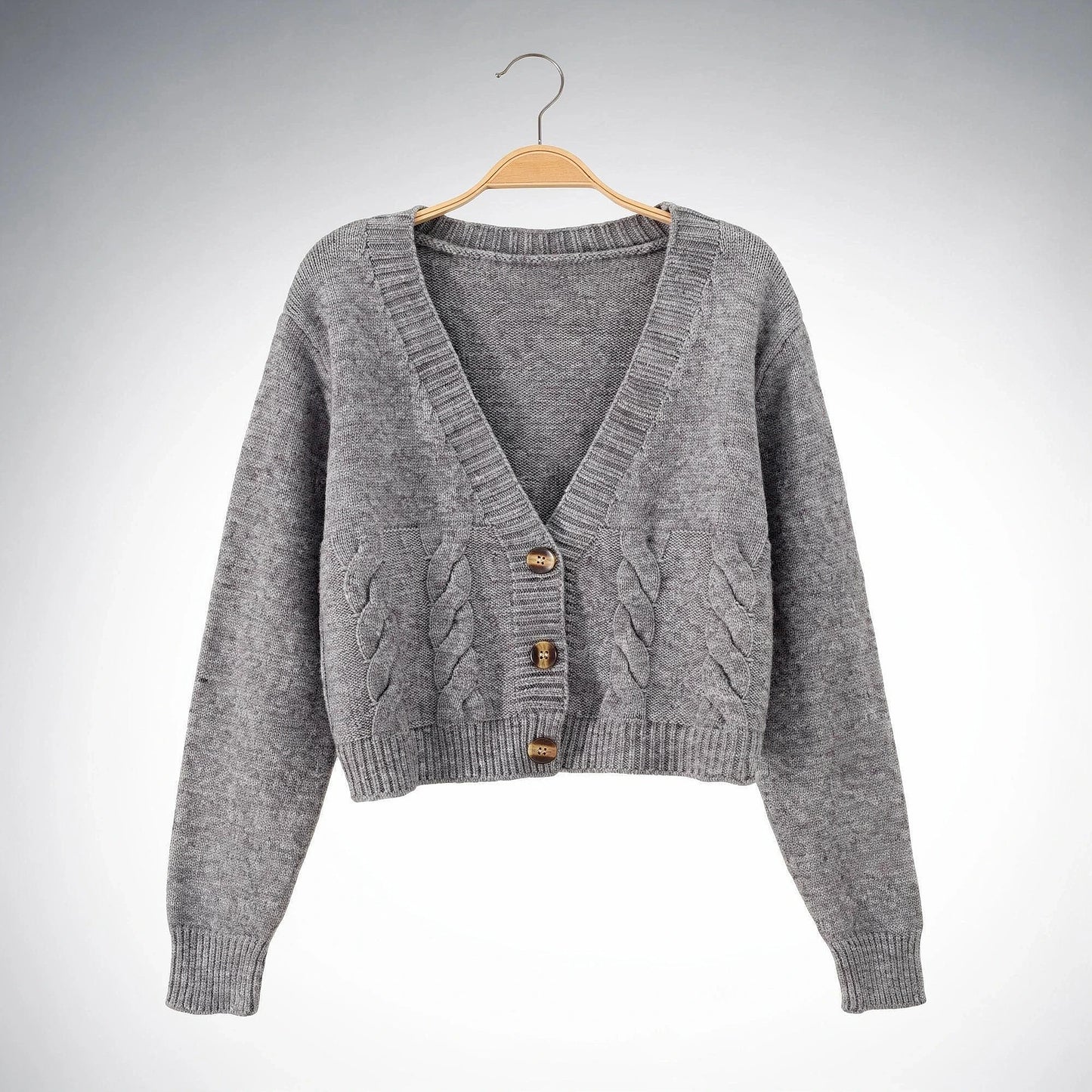 Warm cropped sweater in soft beige knit with a twist at the , showcasing a cozy and stylish design