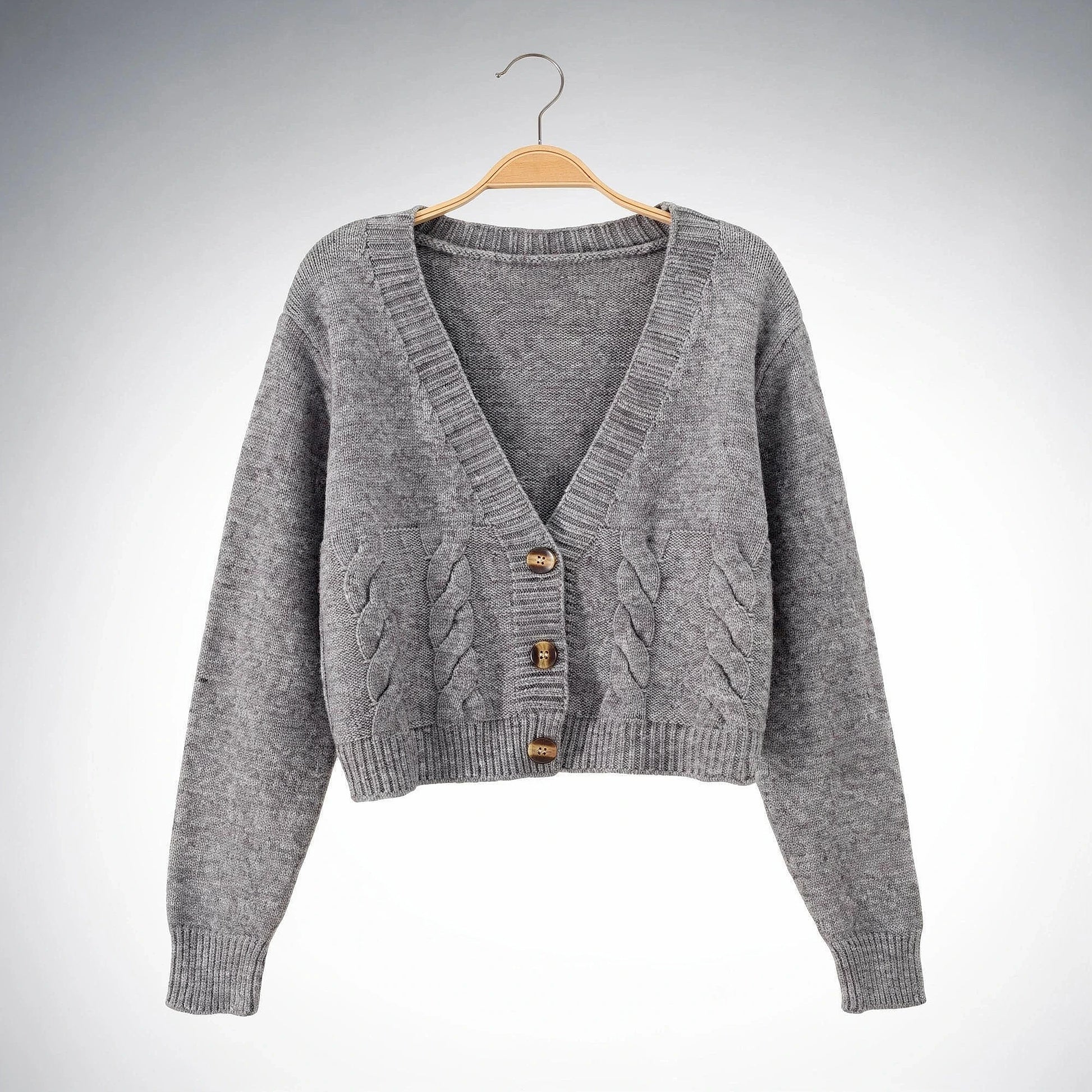 Warm cropped sweater in soft beige knit with a twist at the , showcasing a cozy and stylish design