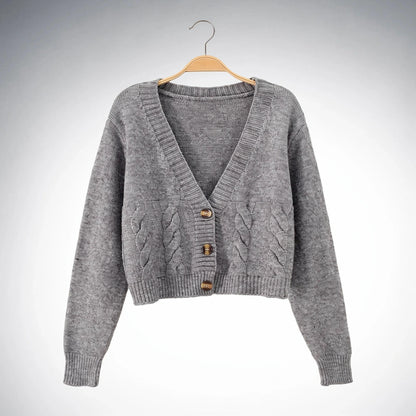 Warm cropped sweater in soft beige knit with a twist at the , showcasing a cozy and stylish design