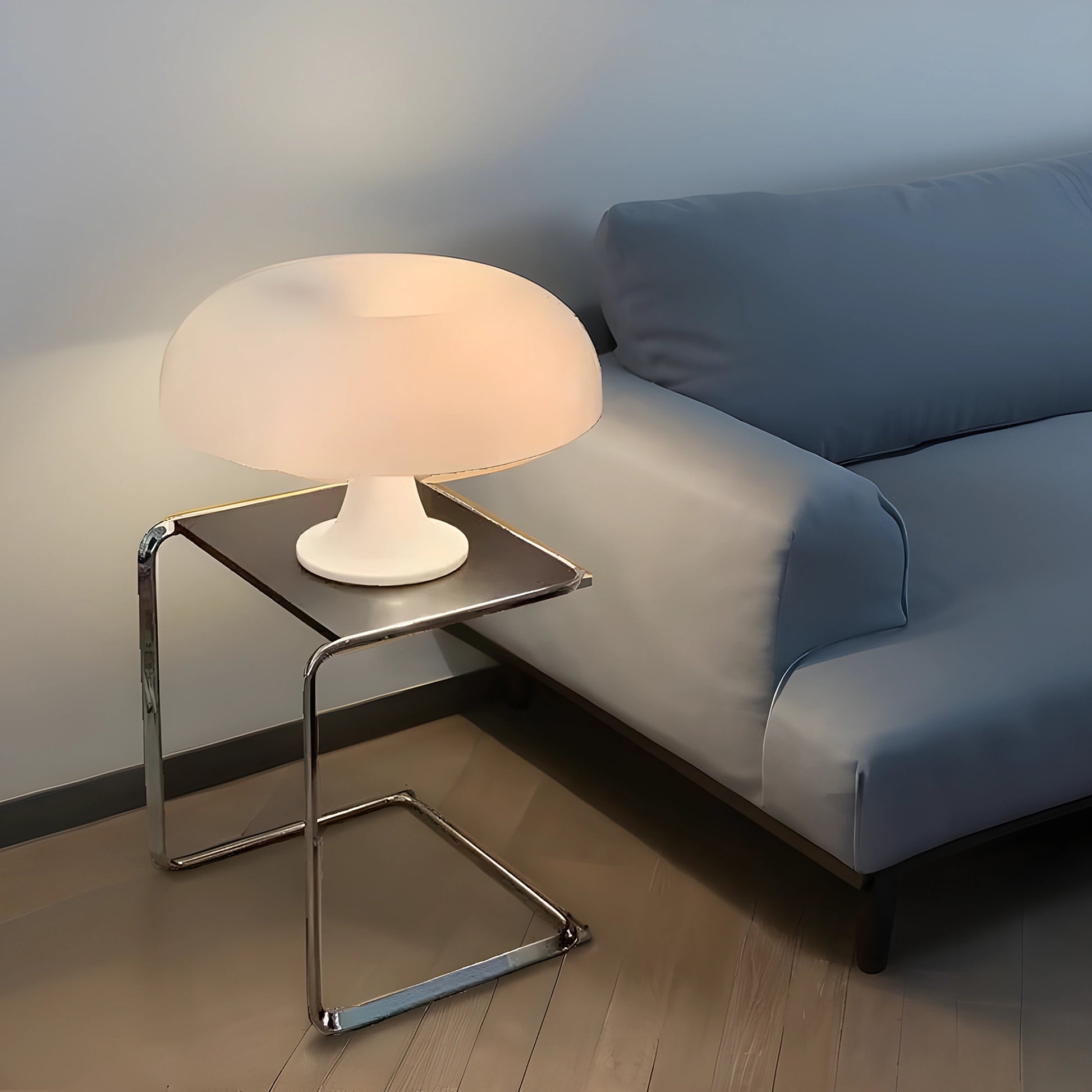 View of a contemporary sculpted acrylic mushroom table lamp featuring a translucent white shade and a sleek, rounded base