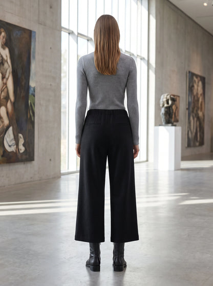 Close up view of the women's tailored autumn cropped trousers showing the fine fabric texture, precise stitching, and design details.