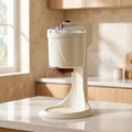 View of a compact electric soft serve ice cream maker, showcasing the control panel, ice cream dispenser, and sleek design