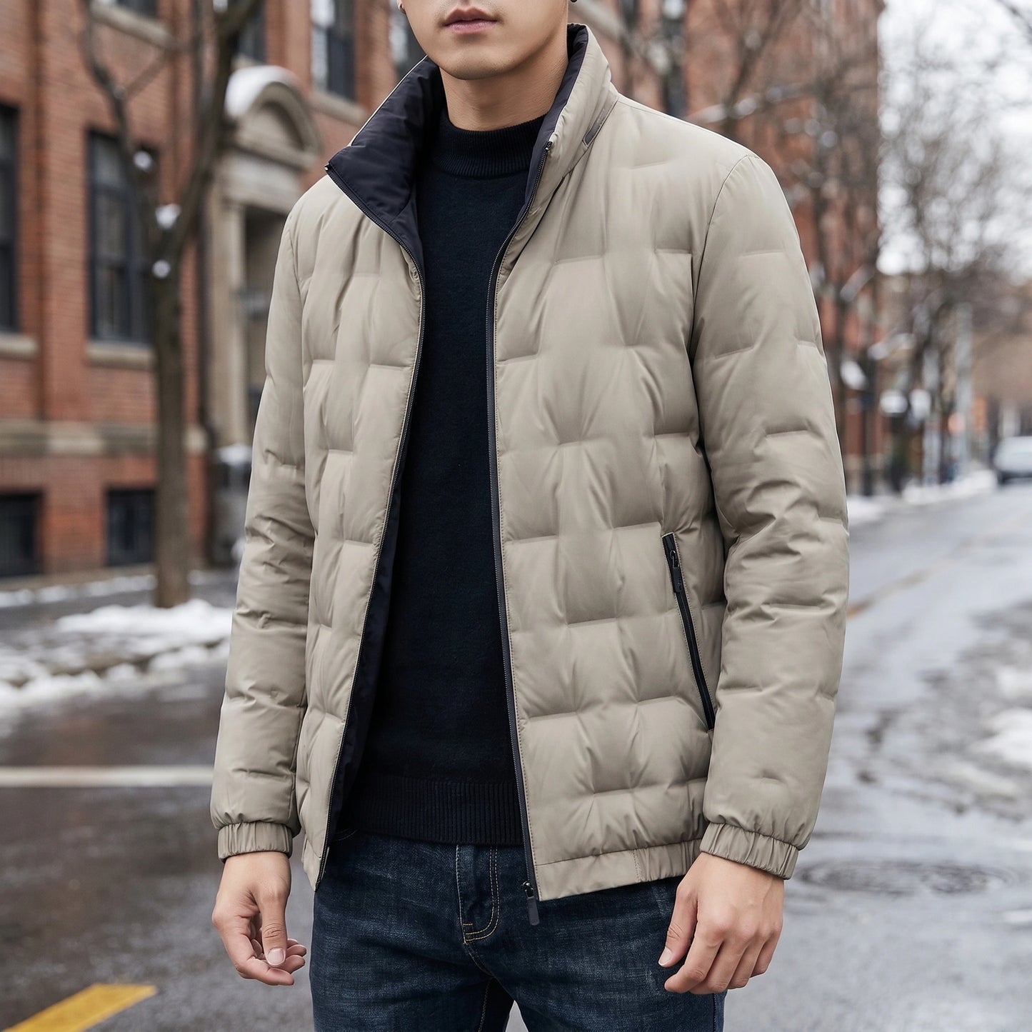 A model showcases a mens lightweight durable winter jacket in navy, styled with a casual outfit against a neutral backdrop, showing its versatility and warmth.