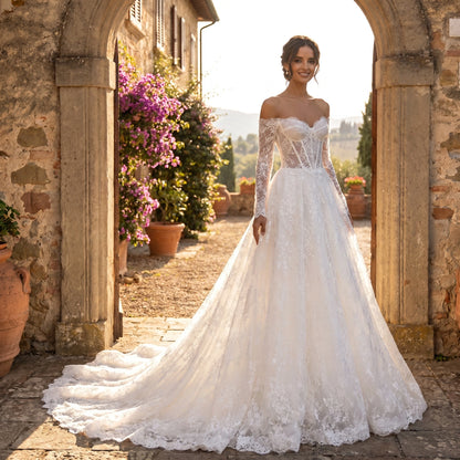 Close up view of the Womens Timeless Wedding Dress showing intricate lace detailing and delicate stitching on a soft ivory fabric against a neutral background.
