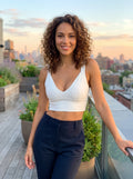 Close up view of the Womens Supportive Cropped Top showing its soft fabric, precise stitching, and design elements against a neutral background.