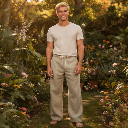 View of wide loose relaxed fit trousers in light beige fabric, featuring a comfortable waistband and pockets
