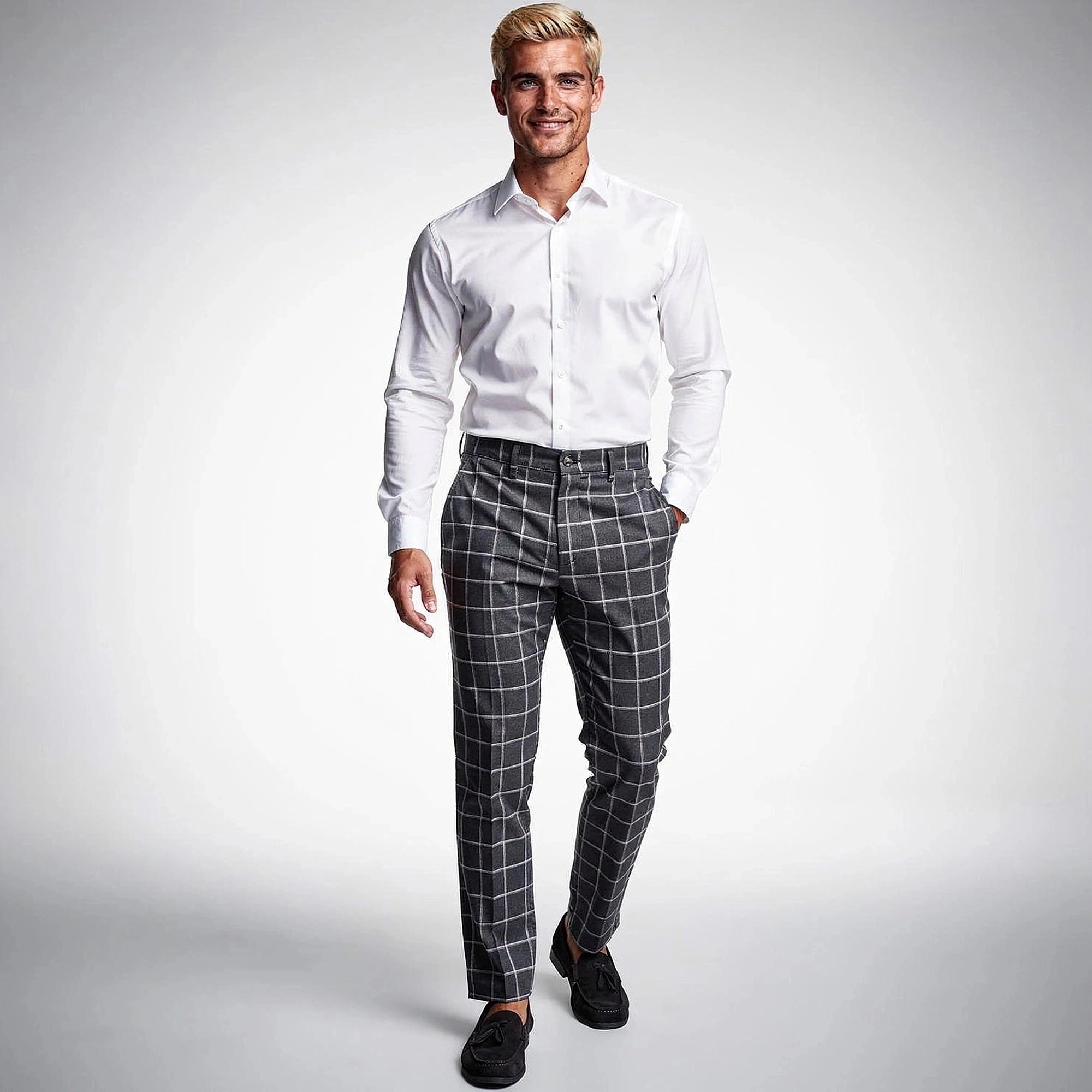 View of tailored tapered trousers in a soft gray fabric, featuring a sleek silhouette and pockets