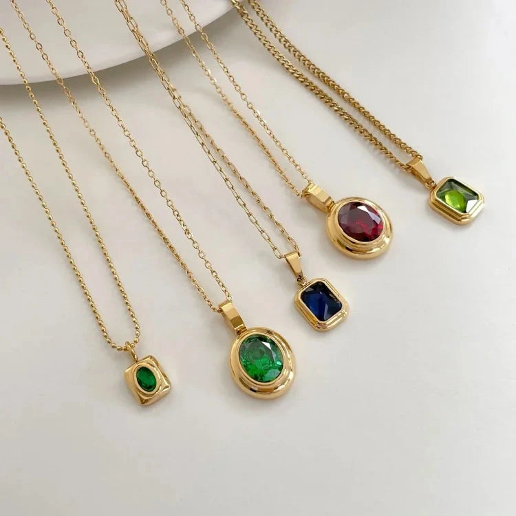 View of a vintage necklace featuring a delicate design with green peridot stones set in a refined metal chain