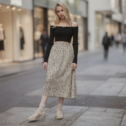 Light pink flowy midi skirt made of soft fabric, featuring a romantic floral pattern and a comfortable elastic waistband