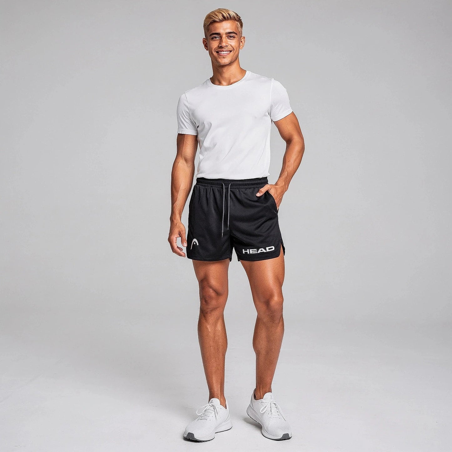 View of fitted athletic running shorts in dark gray, made from quick dry material with an elastic waistband and pockets