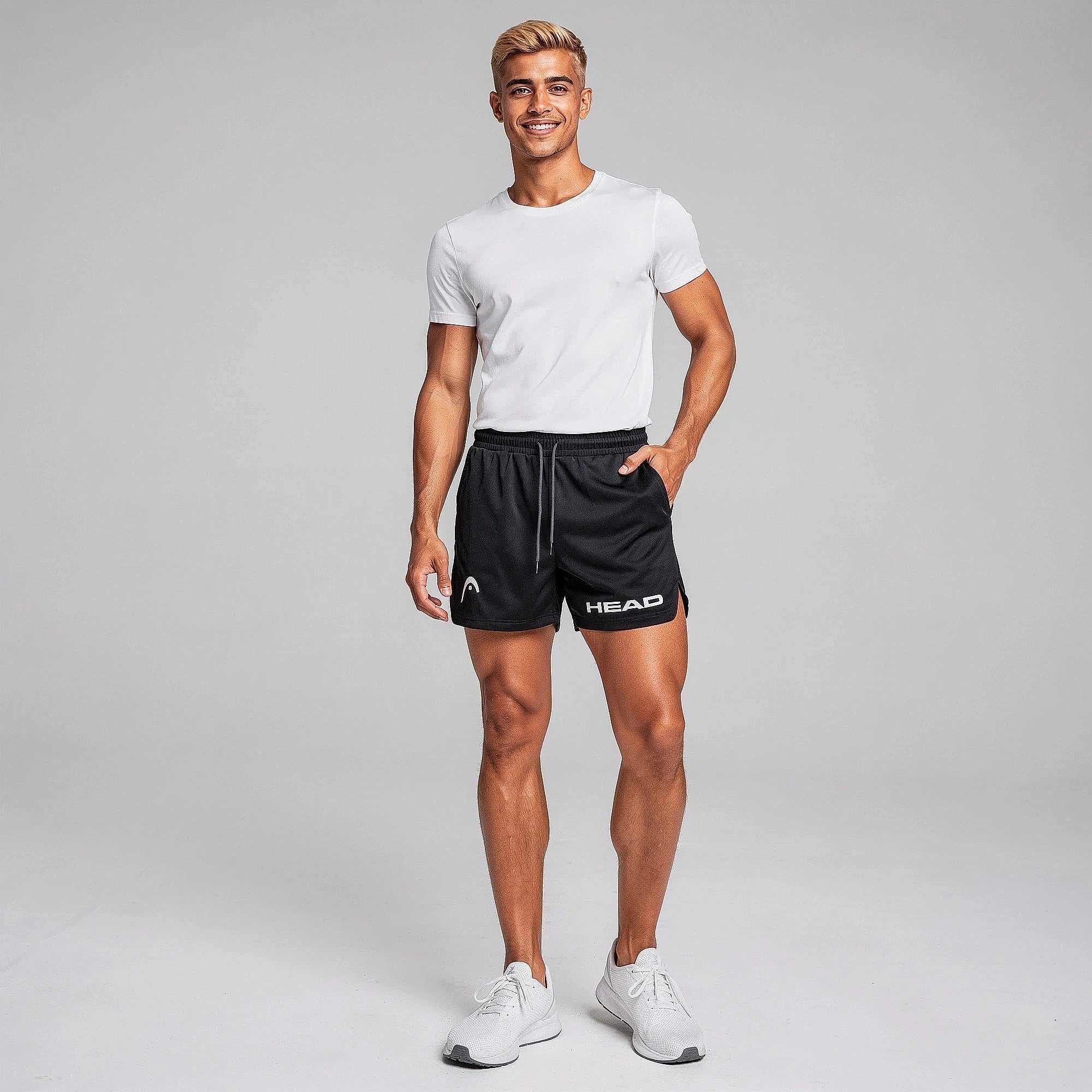 View of fitted athletic running shorts in dark gray, made from quick dry material with an elastic waistband and pockets