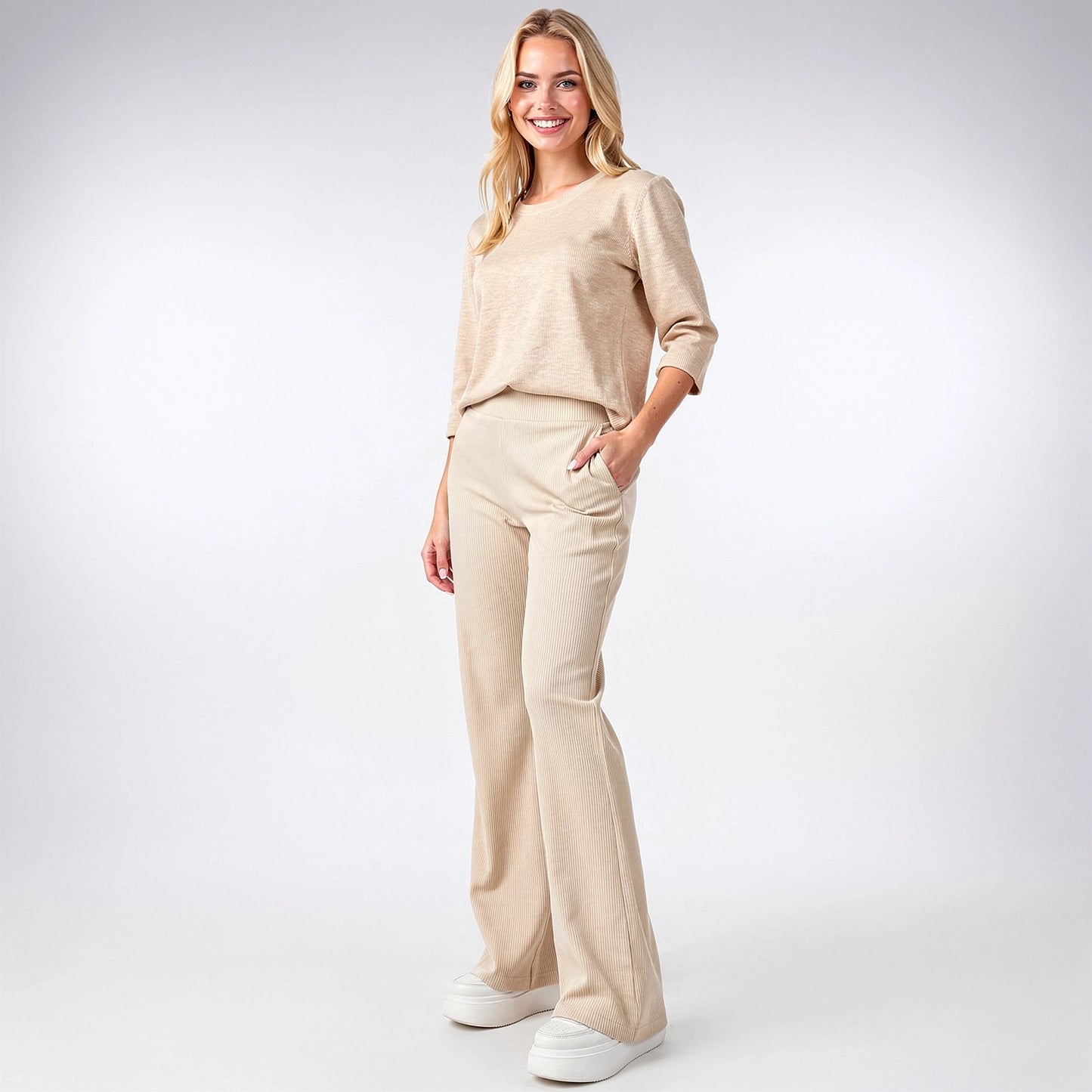 View of stylish flared trousers in soft fabric, featuring a comfortable waistband and elegant draping