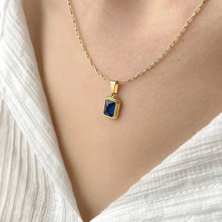 Detailed view of a refined vintage necklace featuring a delicate chain and a stunning peridot gemstone pendant