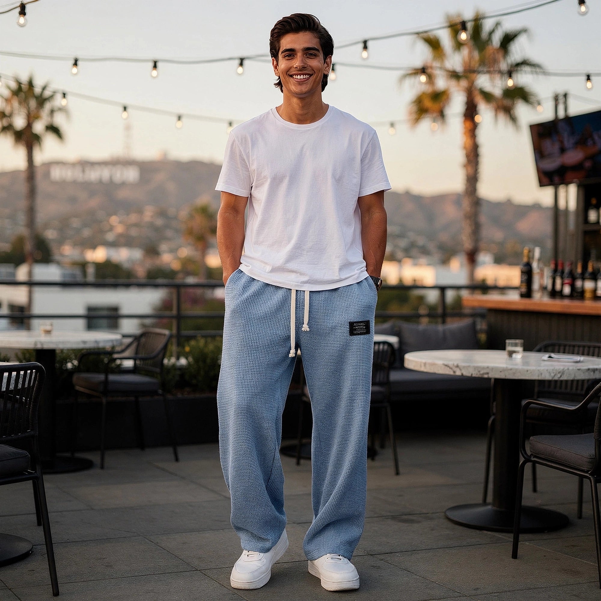 View of relaxed fit drawstring pants in soft cotton fabric, featuring an elastic waistband and pockets