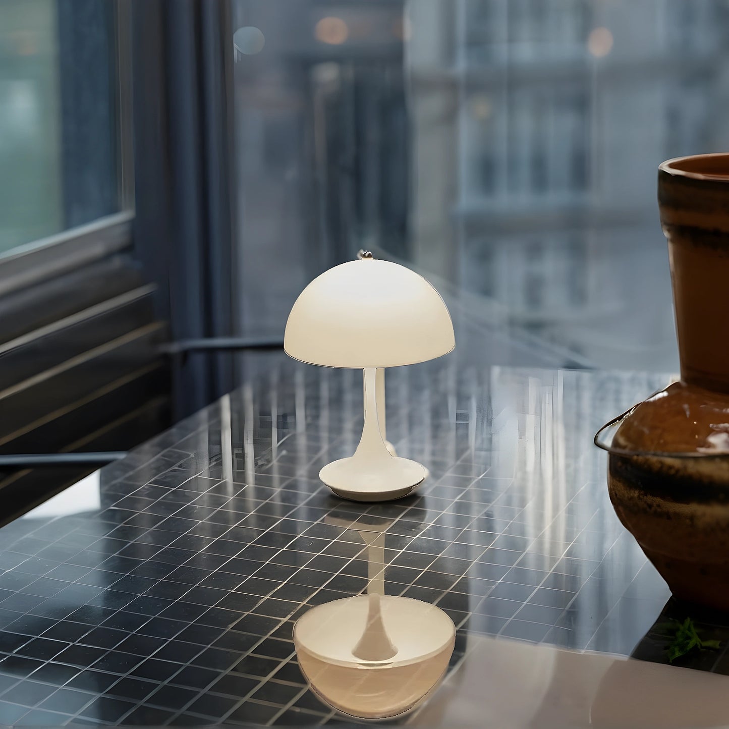 View of a sleek contemporary rechargeable table lamp in a warm brass finish, showcasing its elegant design and smooth curves
