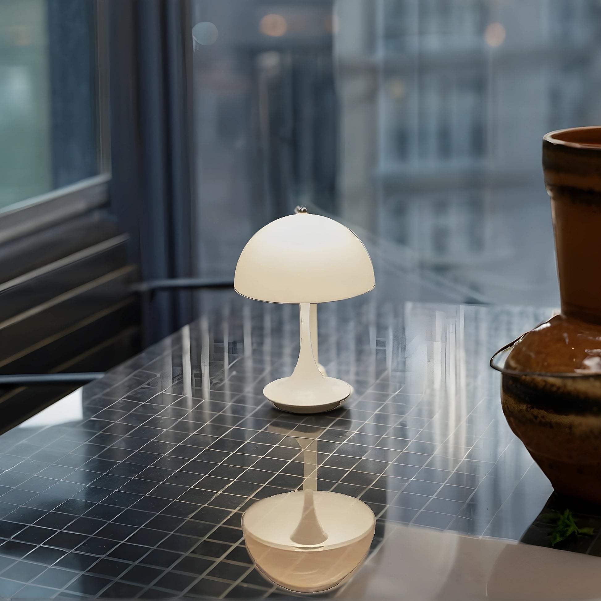 View of a sleek contemporary rechargeable table lamp in a warm brass finish, showcasing its elegant design and smooth curves
