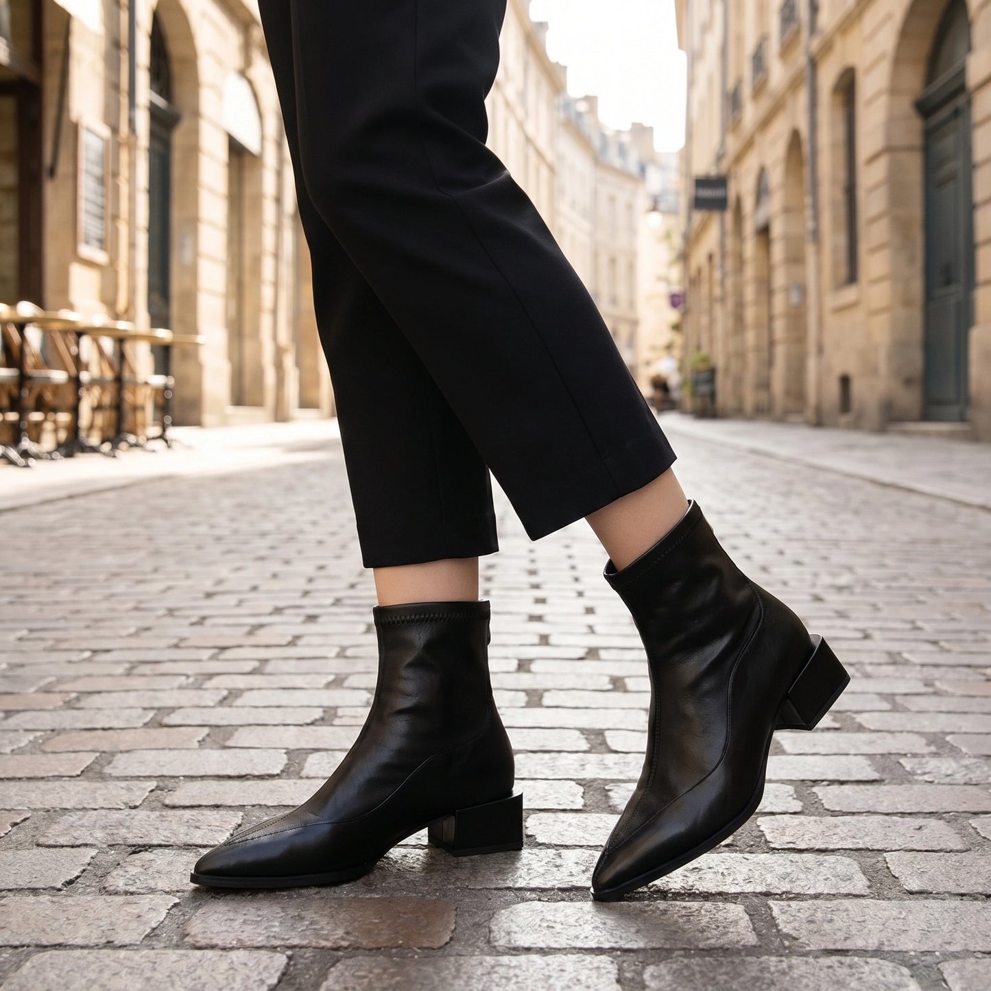 Back view of women's vintage ankle boots in rich brown leather, showing intricate stitching and a silhouette against a neutral backdrop.
