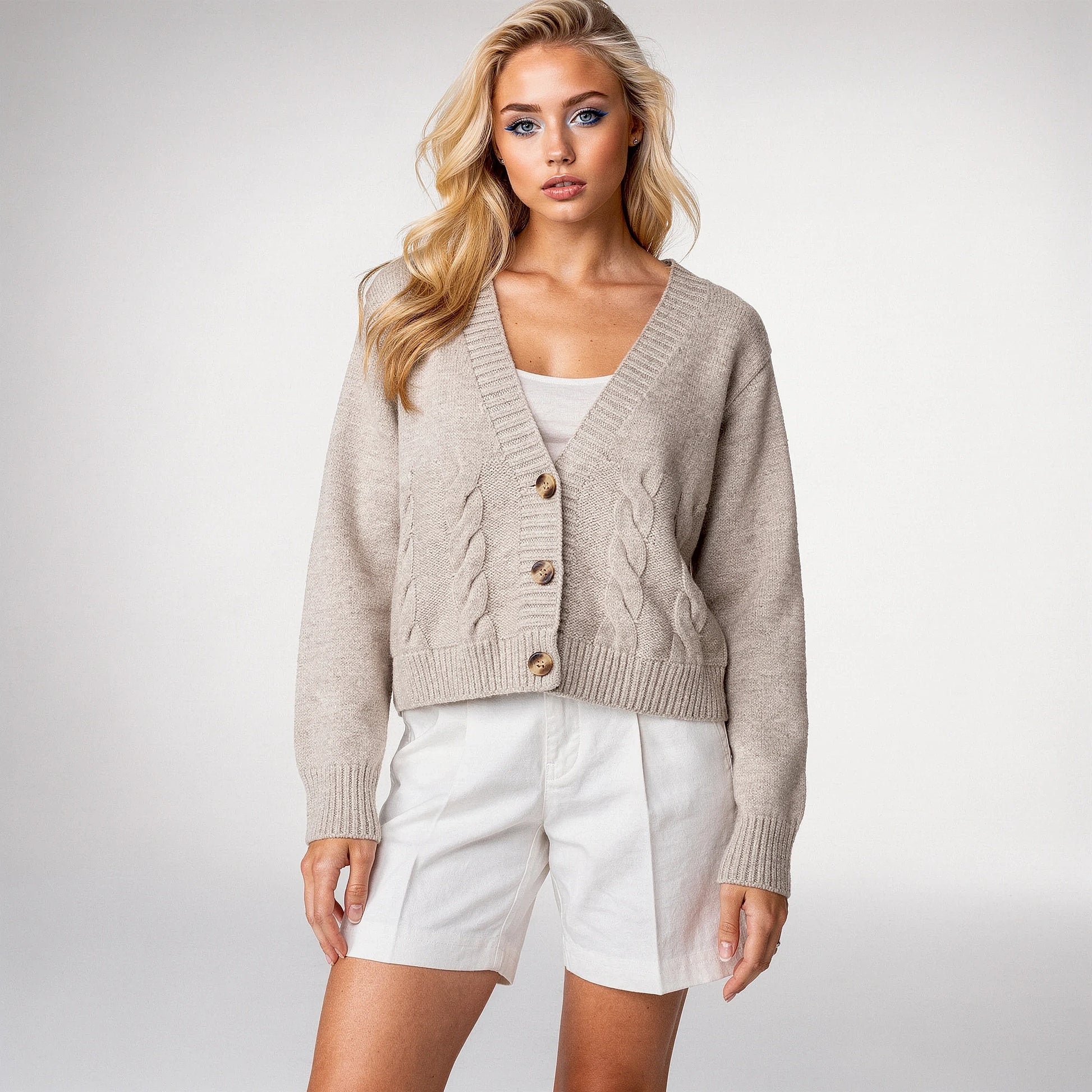 Light gray cropped knitted sweater featuring a twisted , view highlighting the soft texture