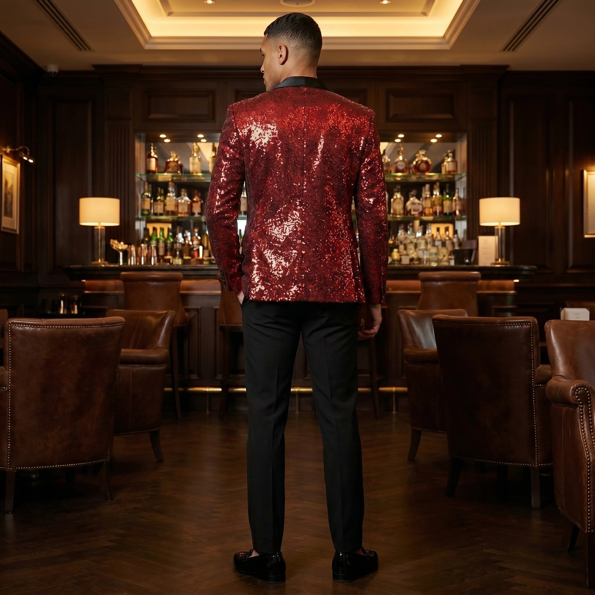 A model showcases the mens dazzling slim fit evening blazer in a sleek black fabric, styled with tailored trousers against a neutral background.