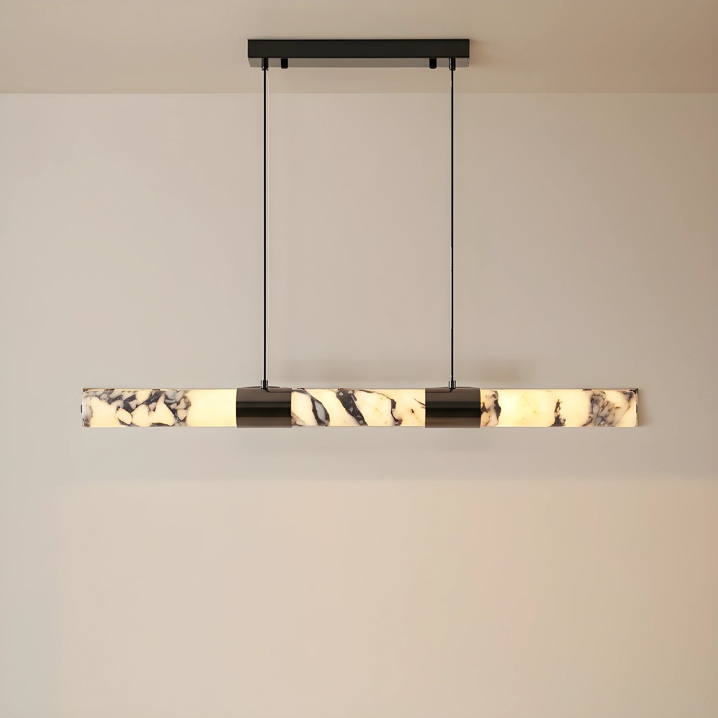 Front view of the AlabasterGlow chandelier, showing its elongated marble design, perfect for enhancing sophisticated dining room aesthetics.