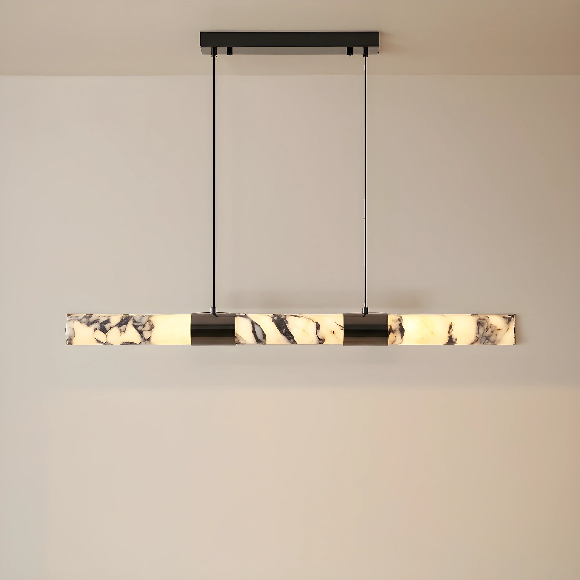 Front view of the AlabasterGlow chandelier, showing its elongated marble design, perfect for enhancing sophisticated dining room aesthetics.