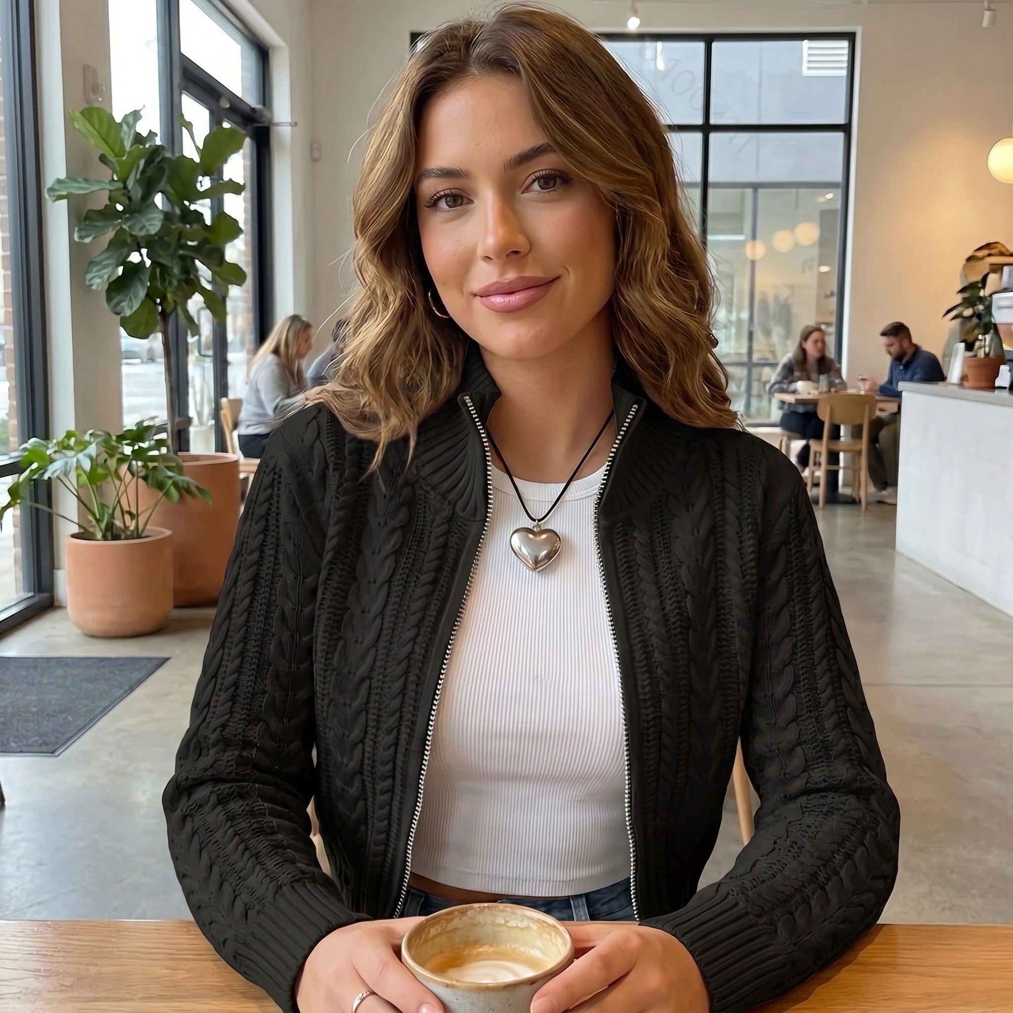 Close up view of the Womens Modern Cropped Cardigan showing the soft fabric texture and precise stitching details in a neutral color.