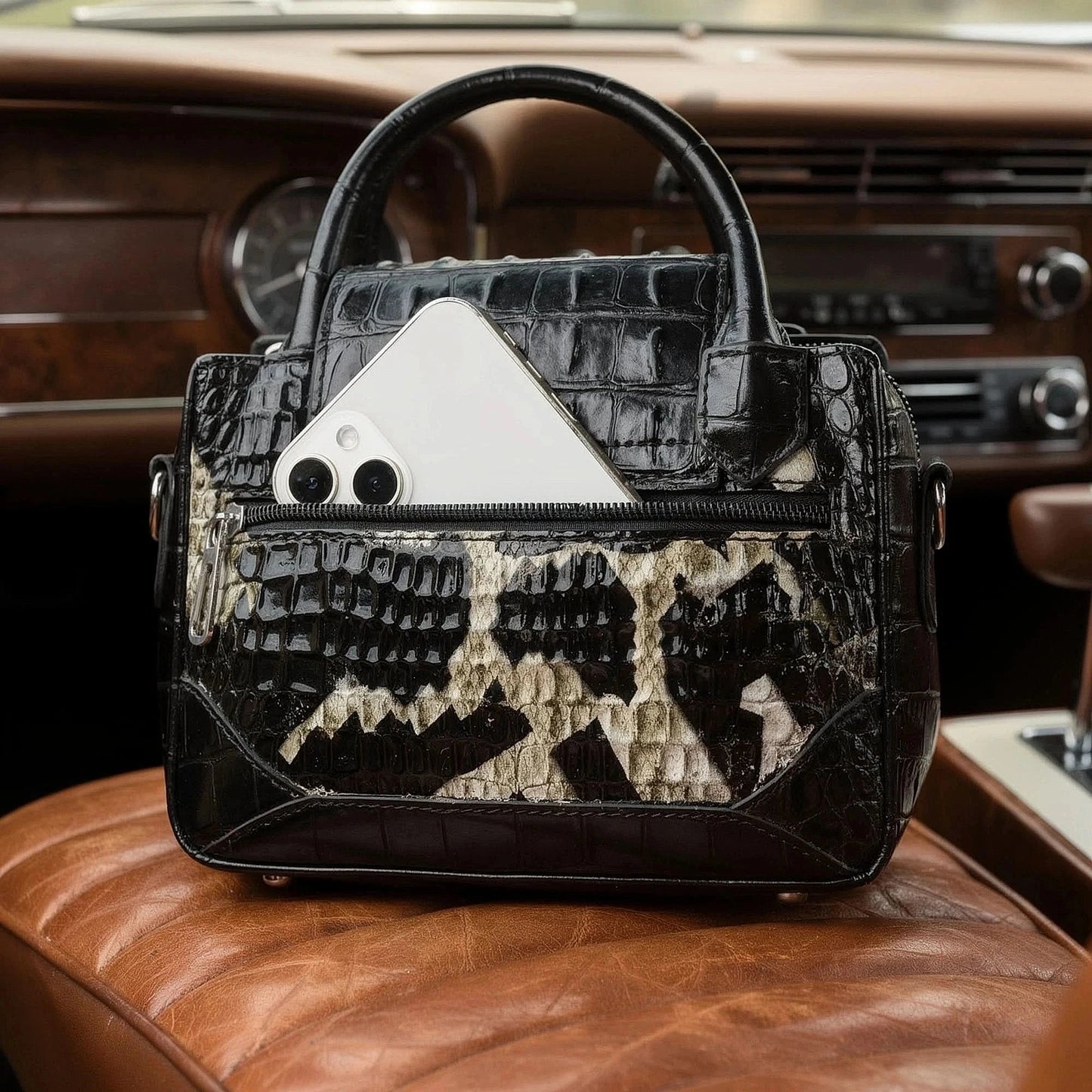 View of a chic textured leather shoulder bag in deep burgundy, featuring a spacious interior and elegant stitching