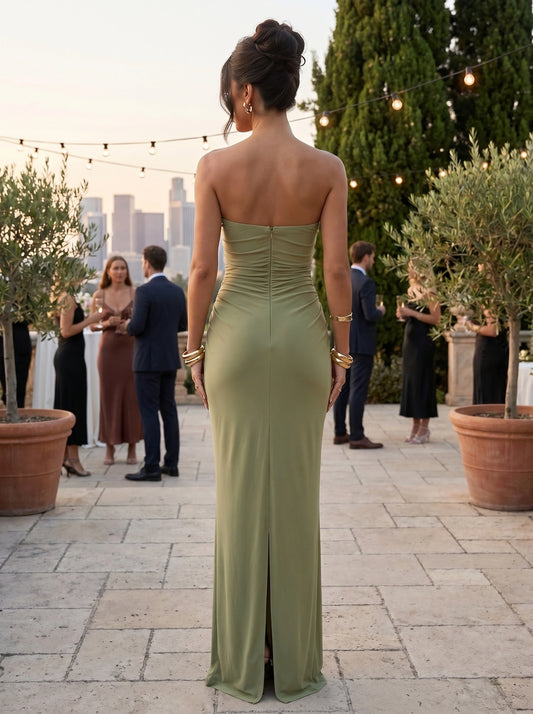 Back view of a model wearing a party dress in a rich burgundy hue, showing intricate stitching and a flattering silhouette against a soft, neutral background.